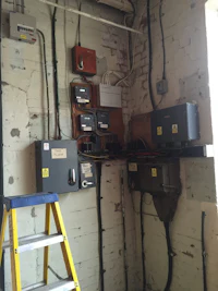 a room with a ladder and some electrical equipment