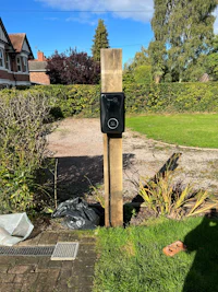 a parking meter on a pole in a grassy area