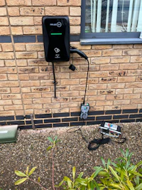 an ev charger is attached to a brick wall
